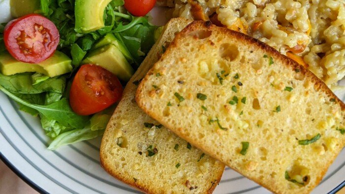 Mushroom Risotto with Two Slices of Garlic Bread ,Slices of tomatoes and avocados 