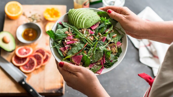 A Person Holding an Avocado Salad